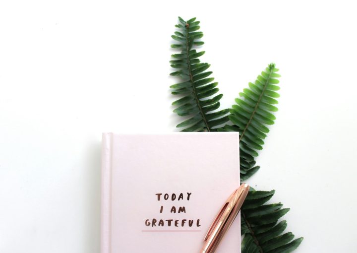 gold pen on top of Today I Am Grateful book